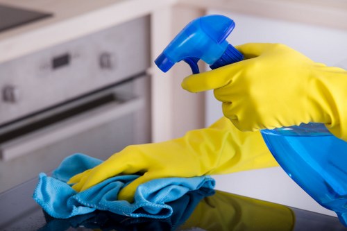 Person cleaning the control panel of an oven